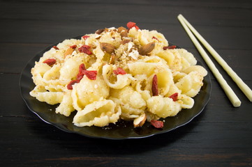 Sweet pasta with nuts, almonds and goji berries