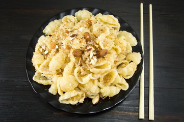 Sweet pasta with nuts and almonds on a plate