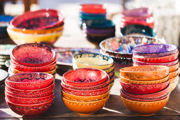 Stack of handmade multicolor Turkish dishes painted with orienta