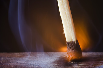 burning match on a black background