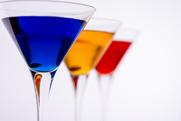 Colorful Cocktails in Martini Glasses Background. Bar Commercials Concept.
