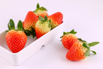 Strawberry from market in a white bowl isolated on white background.