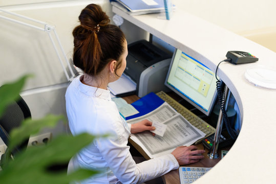 Female receptionist working the computer