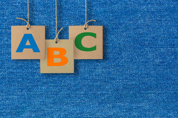 ABC letters on cardboard. Alphabet design on  jeans background.