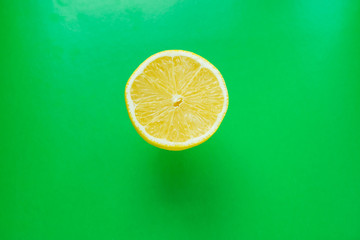 a half of a lemon on a green background.pop art