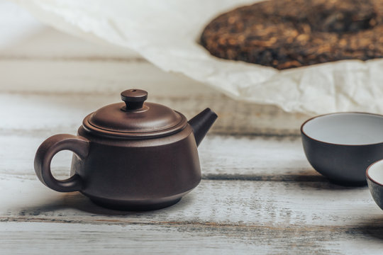 Teapot from Yixing clay for Chinese tea ceremony on rustic wooden background 