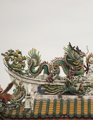 Fototapeta premium Dragon statue on roof with sky background. Traditional Chinese style art