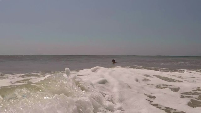 Child, Little Girl Swimming in Sea Water, young Lady plays in surf, beach
