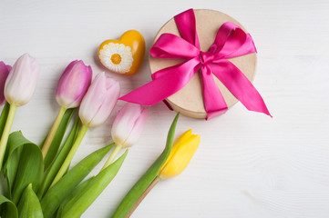 Red pink yellow tulips and gift box with red ribbon