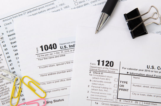 US tax form 1040, 1120 on desk