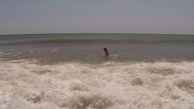 Child, Little Girl Swimming in Sea Water, young Lady plays in surf, beach