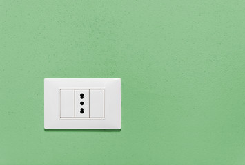 Empty Wall Socket on a Green Wall