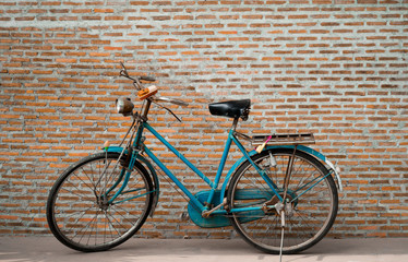 Fototapeta na wymiar Classic Retro Bicycle Parked brick wall