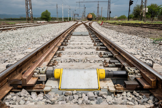 Railroad tracks closeup with derailing block in foreground