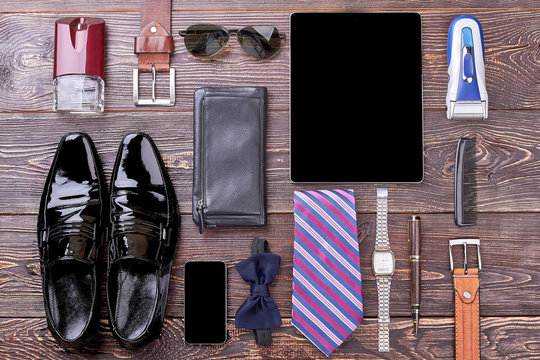 Watch, shoes and gadgets. Bow tie, wallet and cologne. Good look by few steps.