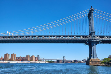 Fototapeta na wymiar Manhattan Bridge crossing East River with Williamsburg Bridge in the background in New York City