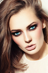 Portrait of young beautiful blue-eyed woman with smoky eyes