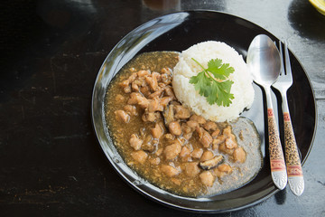 chicken with sauce over rice.