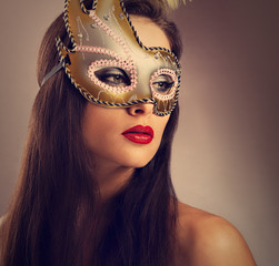 Beautiful emotion woman posing in carnival mask with bright make