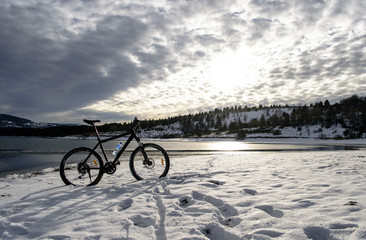 Fototapeta na wymiar Cycling on lake. Winter