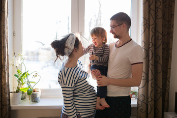 happy family with  son kid toddler playing near window real inte