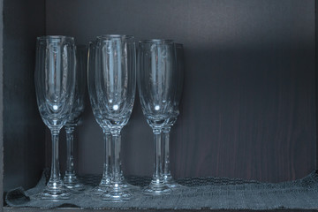 Closeup of a kitchen cupboard with glass shelf and drinking glasses
