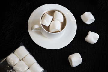 
hot chocolate with marshmallow on a black background