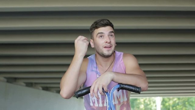 Street jumper is tired and wipes the sweat from his forehead his hand.