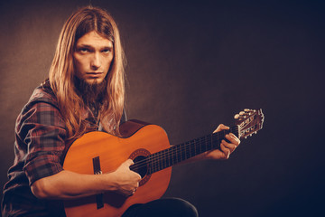 Guitarist trying out chords.
