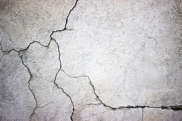 cracked concrete wall covered with gray cement surface as backgr