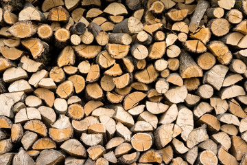 wall firewood , Background of dry chopped firewood logs in a pil