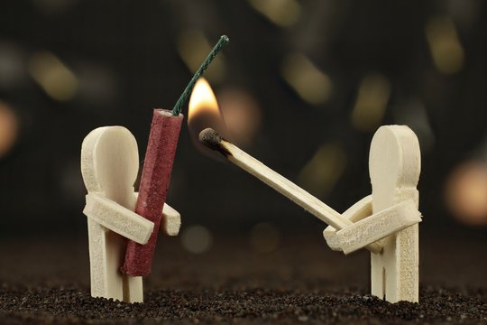 Ein M&auml;nnchen h&auml;lt B&ouml;ller &ndash; das zweite mit brennenden Streichholz 