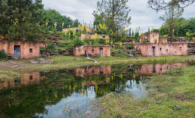 Fototapeta premium Terracotta houses with reflection in a pond
