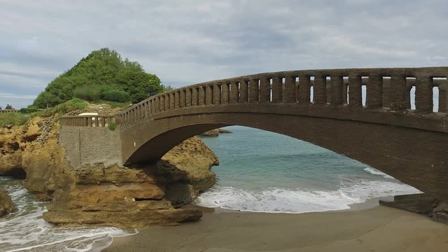 Stone bridge to the islet Rocher Du Basta  11 / Dolly Truck Left Away from the bridge on the islet called Rocher du Basta a beautiful cloudy day on the beach of Biarritz with waves