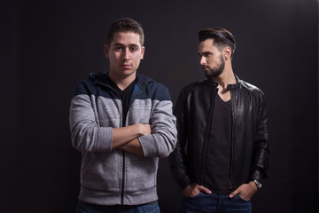 Two young adult men posing studio