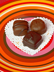 Dark chocolate Candy Truffles on a Heart Shaped Doily