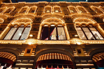Christmas and New Year lights decoration and festive illuminations in streets of city, Red Square, Moscow, Russia. Building is decorated for holiday.