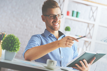 Businessman writing in organizer