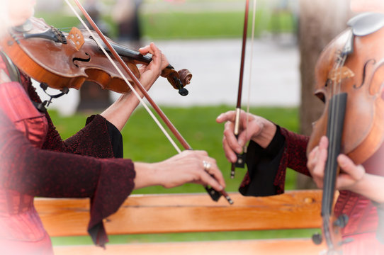 two women practicing violin