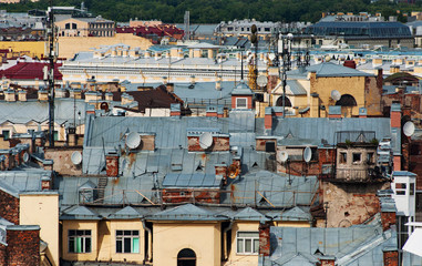 Fototapeta na wymiar Old buildings roofs with satellites in the center of Saint-Petersburg. Russia