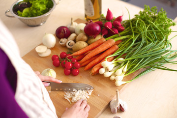 Young Woman Cooking in the kitchen. Healthy Food