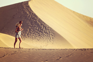 Mother with son walking in a desert in Gran Canaria