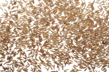 Pile of cumin seeds isolated on white background