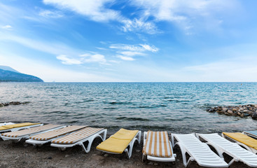 Row of empty sunbeds on a hotel beach. Morning in tourist resort