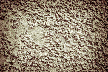 Fragment of  old grungy texture with chipped paint and cracks or toned concrete wall and cement surface with small stones dirty elements