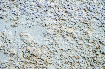 Fragment of  old grungy texture with chipped paint and cracks or toned concrete wall and cement surface with small stones dirty elements