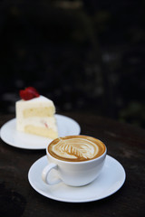 cappuccino coffee with cake on wood background
