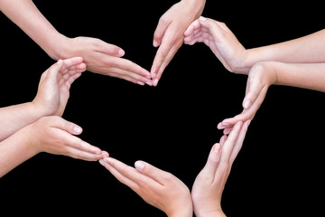Arms and hands of girls making heart shape