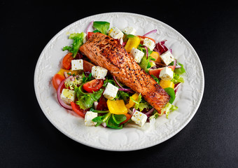 Fried Salmon steak with fresh vegetables salad. concept healthy food.