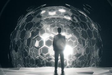 Man in front of silver sphere